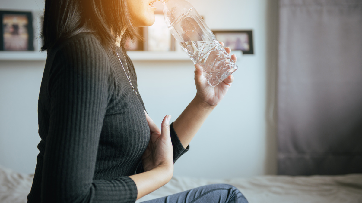 Seated woman suffering from acid reflux